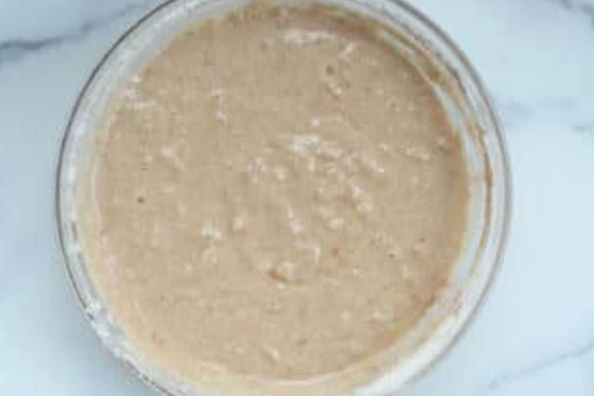 Batter for chocolate chip banana cake in glass bowl.