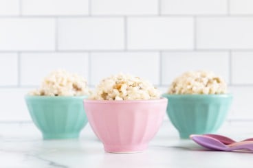 Rice pudding in three bowls with spoons.