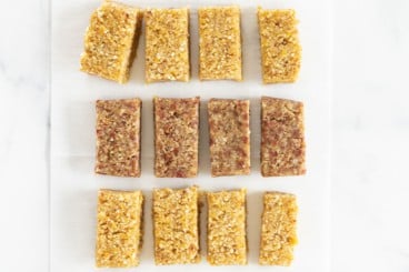 Fruit and nut bars cut on parchment paper.