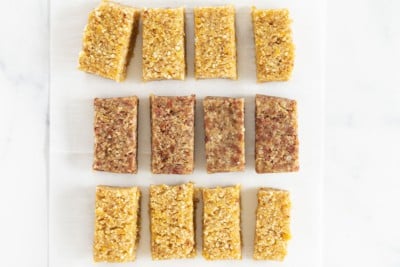 Fruit and nut bars cut on parchment paper.