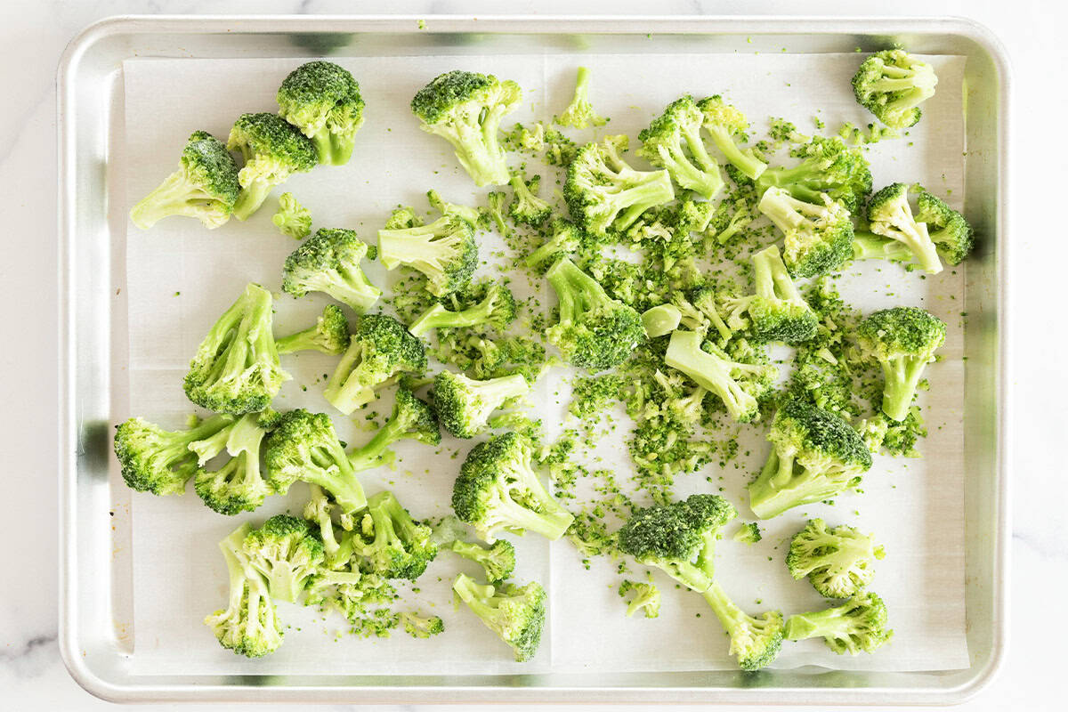 Frozen broccoli on baking sheet before baking. 