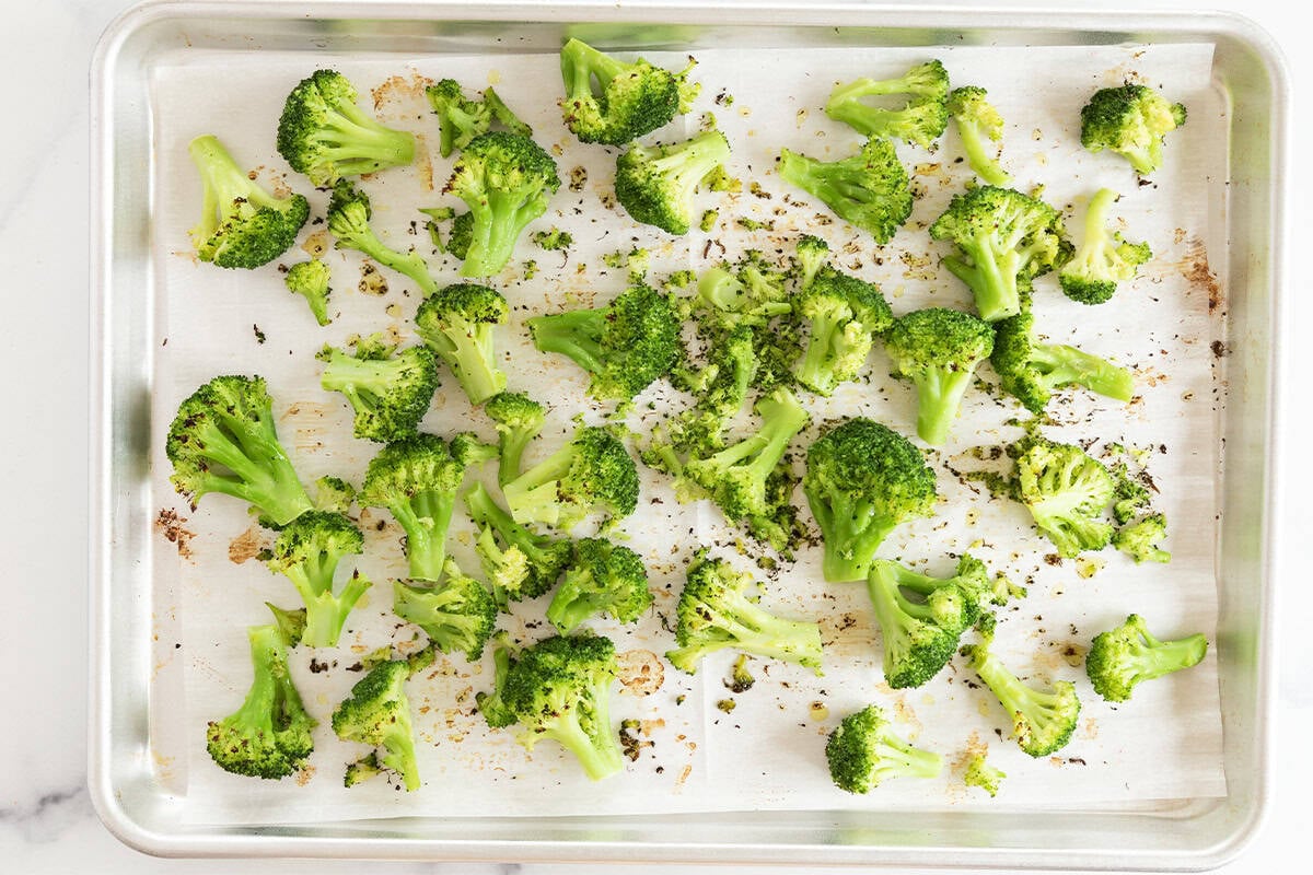 Frozen roasted broccoli on baking sheet.