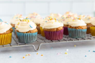 carrot cake cupcakes on rack.