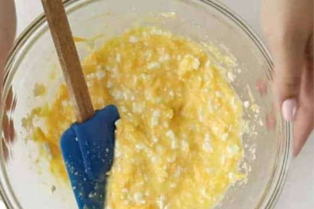 Egg mixture in glass bowl for mini egg muffins.