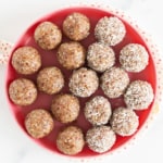 Bliss balls on red plate.