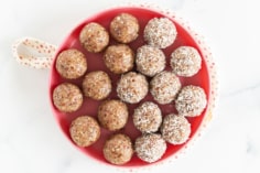 Bliss balls on red plate.