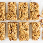 Peach crumb bars cut into bars with peaches on side.