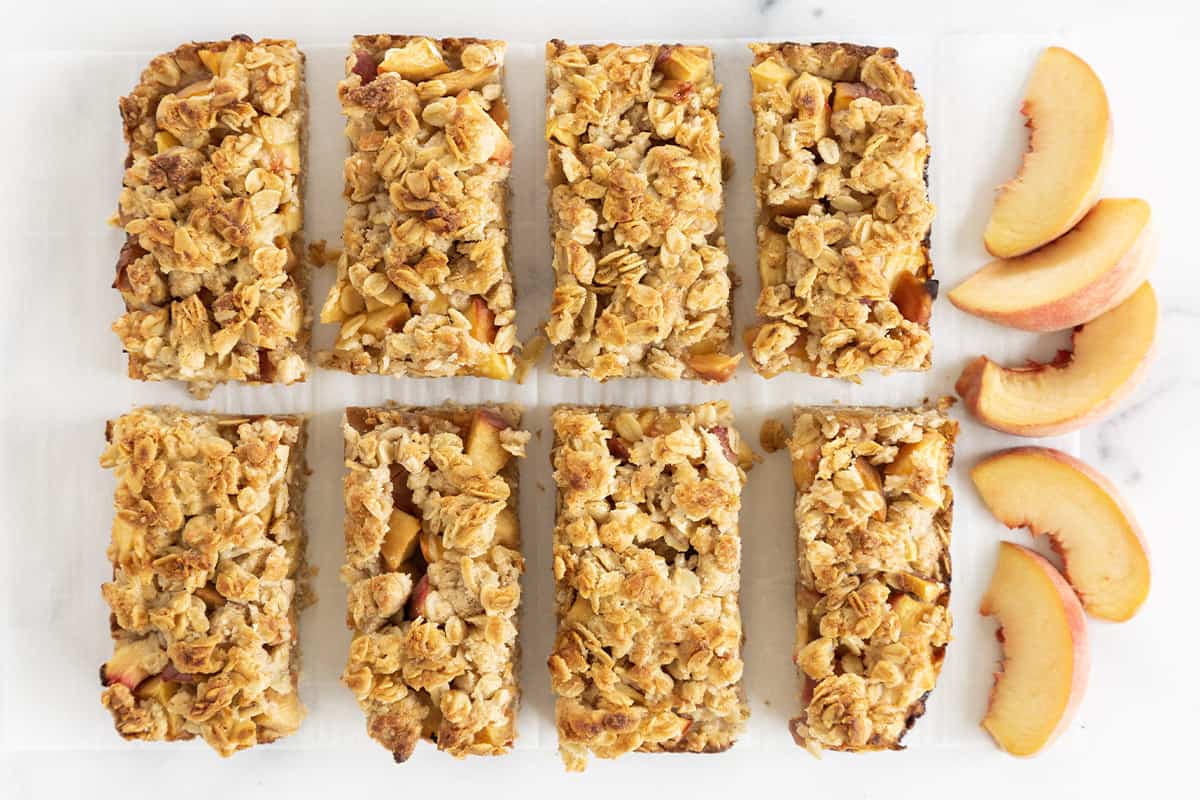Peach crumb bars cut into bars with peaches on side. 