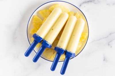 Pineapple popsicles on plate with pineapple.