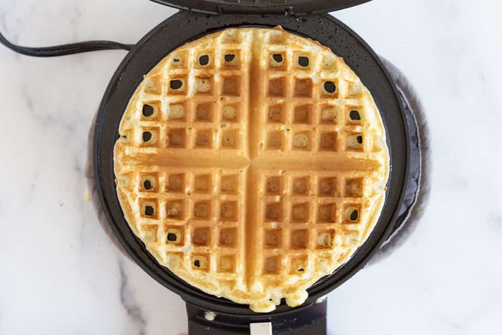 Yogurt waffle in waffle iron after cooking.