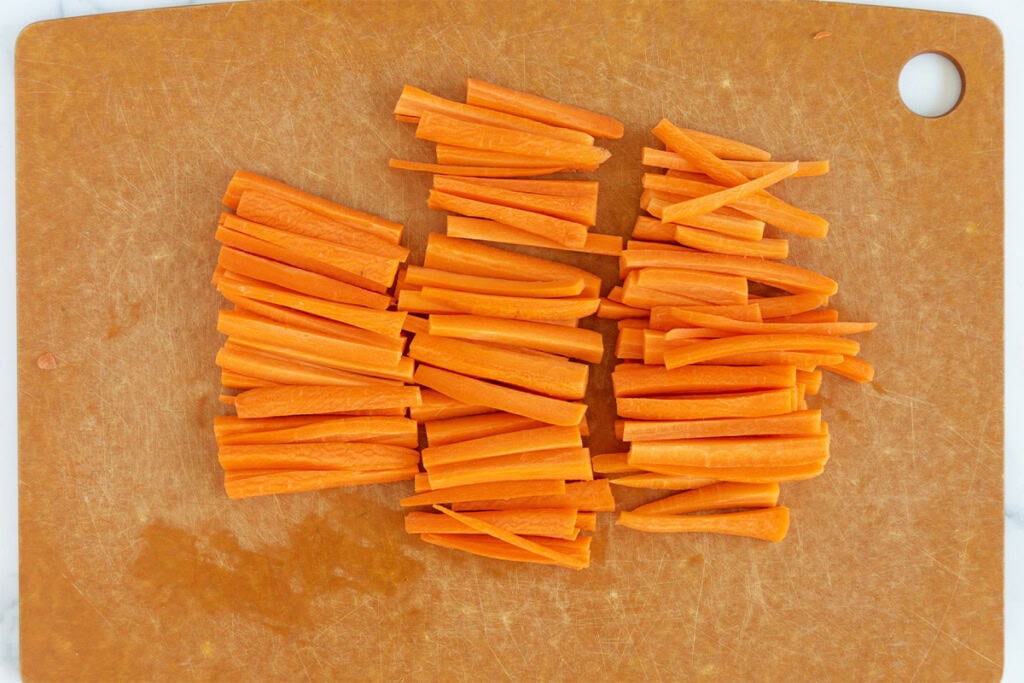 Carrot slices on cutting board for air fryer roasted carrots.