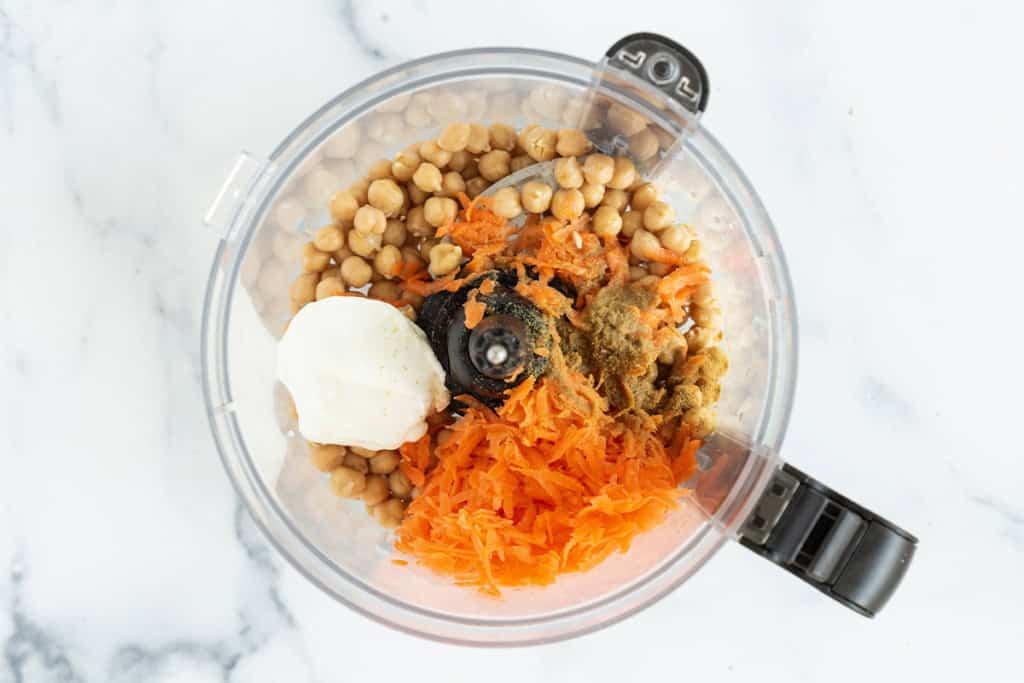 Ingredients for carrot hummus in food processor.