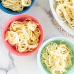 cauliflower alfredo sauce with pasta in colorful bowls.