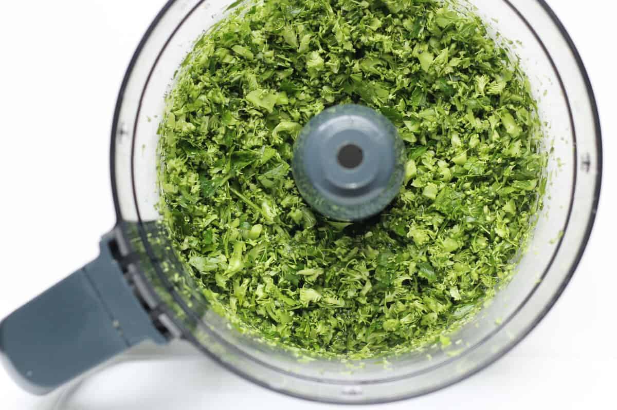 Making broccoli pesto in a food processor.