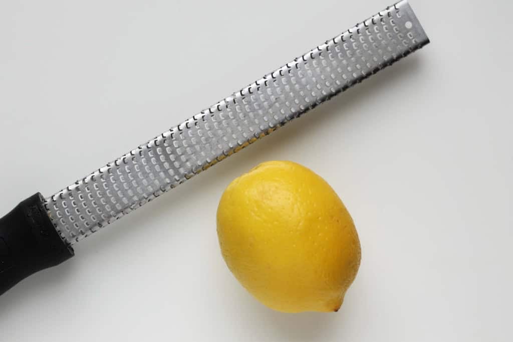 A micro grater with a lemon for broccoli pesto.