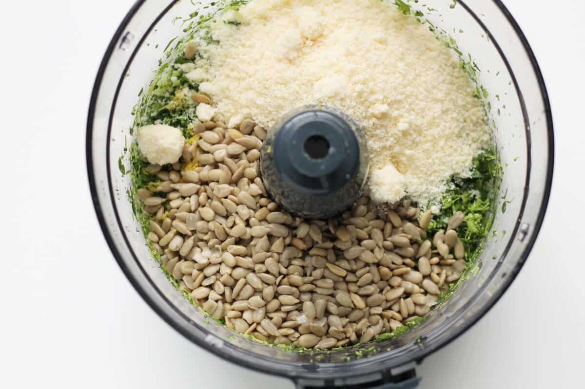 Ingredients for broccoli pesto in food processor before blending.