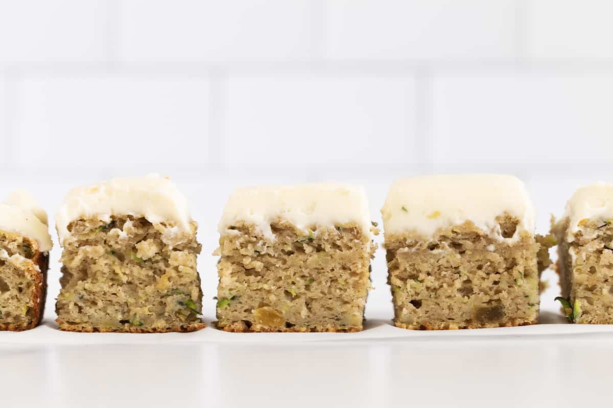 Zucchini cake cut into squares from the side. 