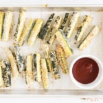 Zucchini fries on pan with ketchup.