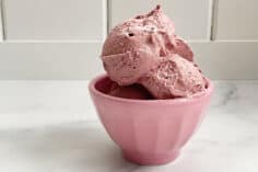 blueberry ice cream scoops in pink bowl