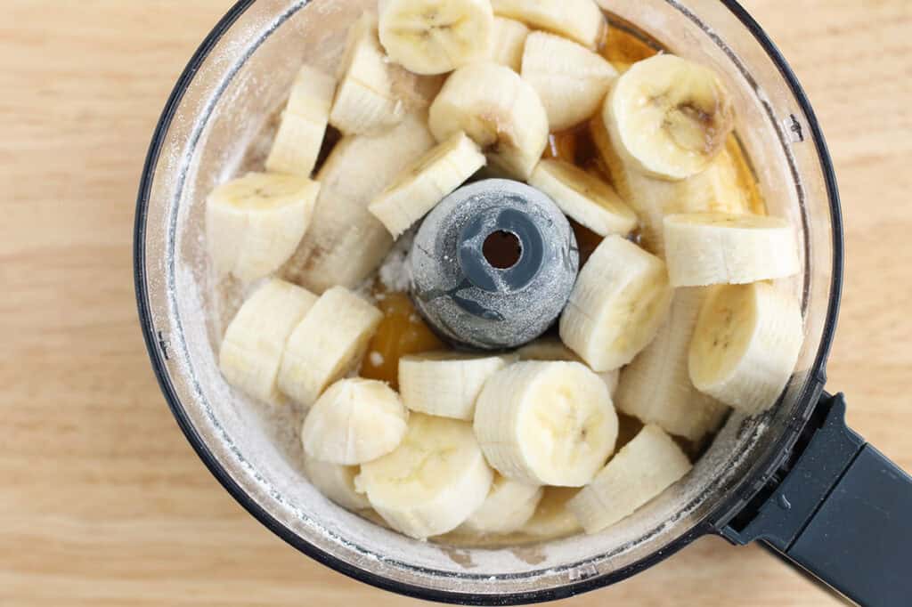 ingredients for oatmeal banana bread in food processor.