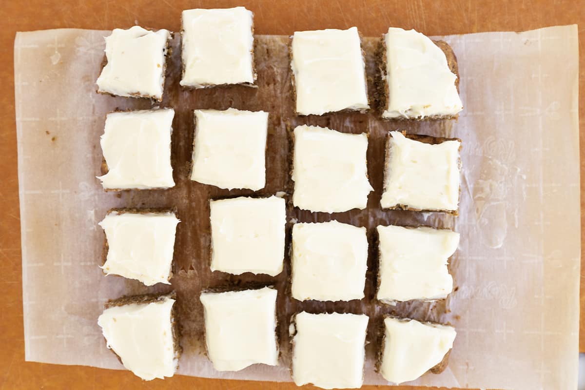 Applesauce cake with frosting cut into squares.