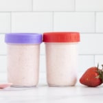 Blended overnight oats in two containers with lids and spoon.