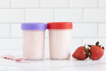 Blended overnight oats in two containers with lids and spoon.