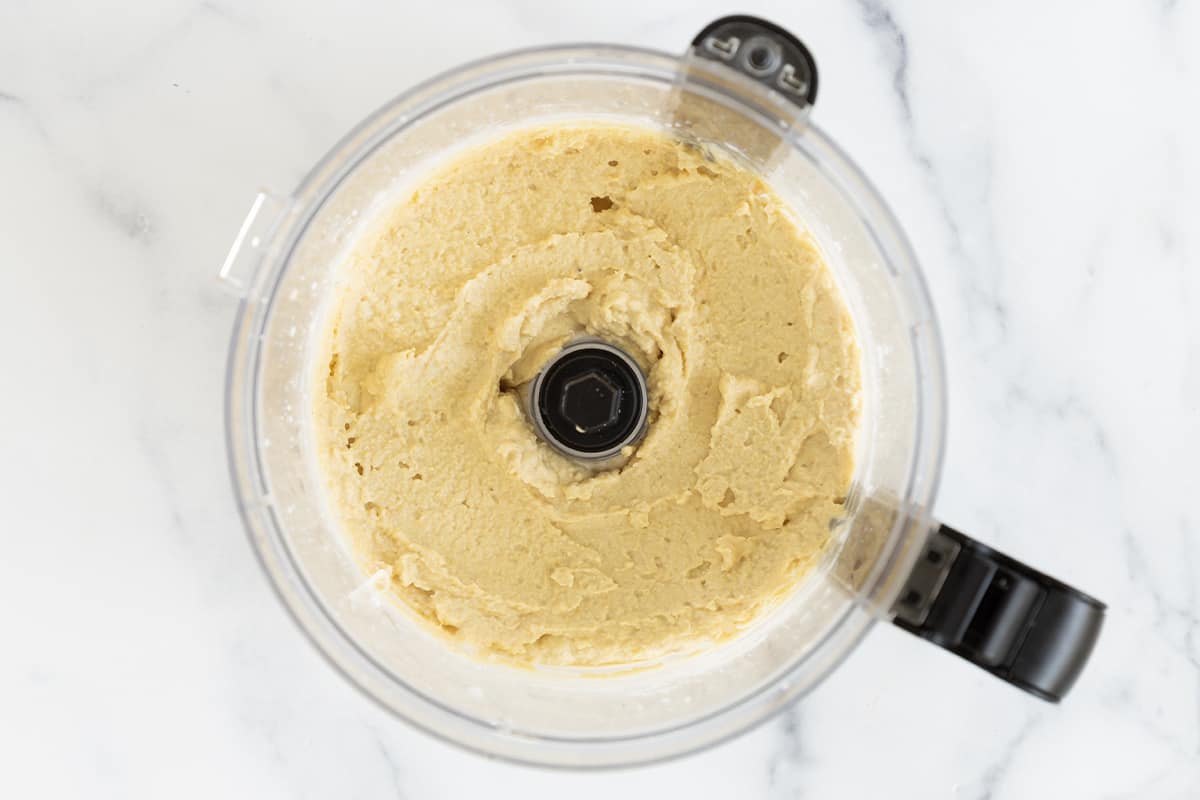 blended hummus without tahini in food processor.