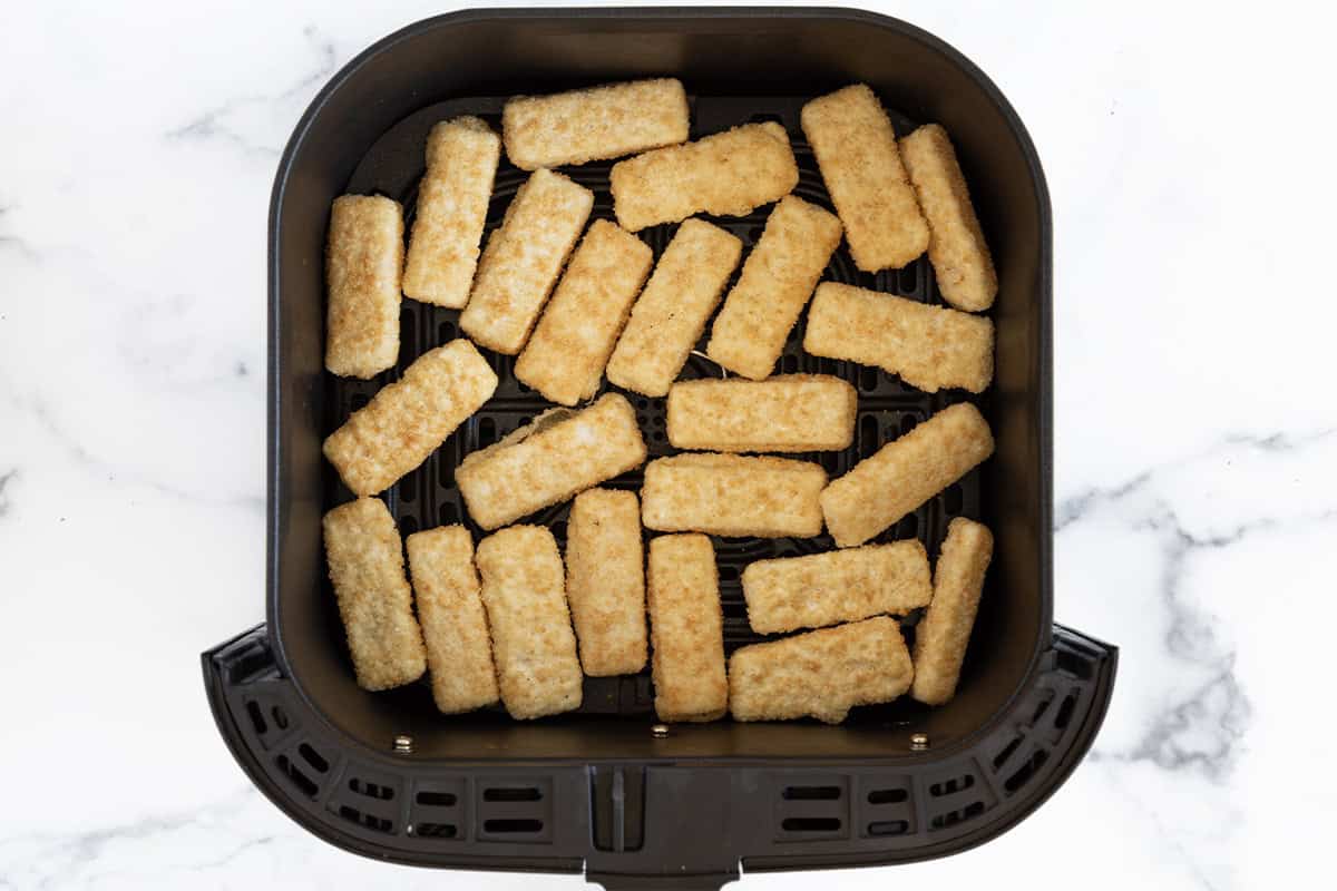 Fish sticks in air fryer before cooking for fish stick tacos. 