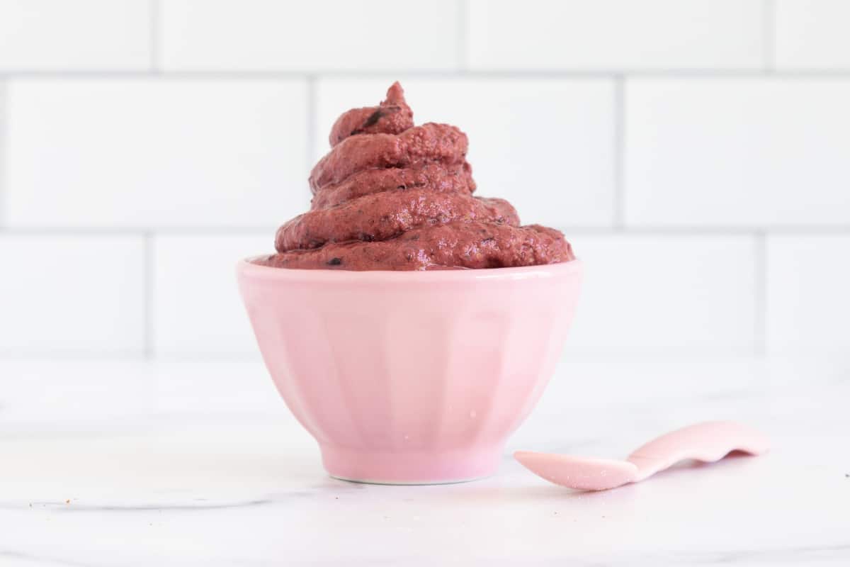frozen yogurt in pink bowl with spoon.