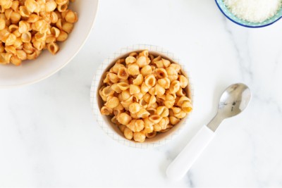 Lentil pasta in two white bowls with spoon.