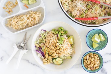 Rice noodle salad in multiple bowls with sides.