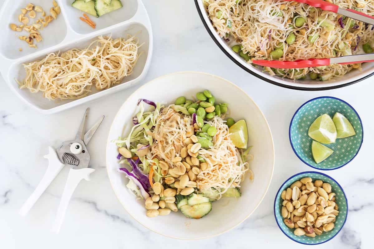 Rice noodle salad in multiple bowls with sides. 