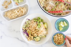 Rice noodle salad in multiple bowls with sides.