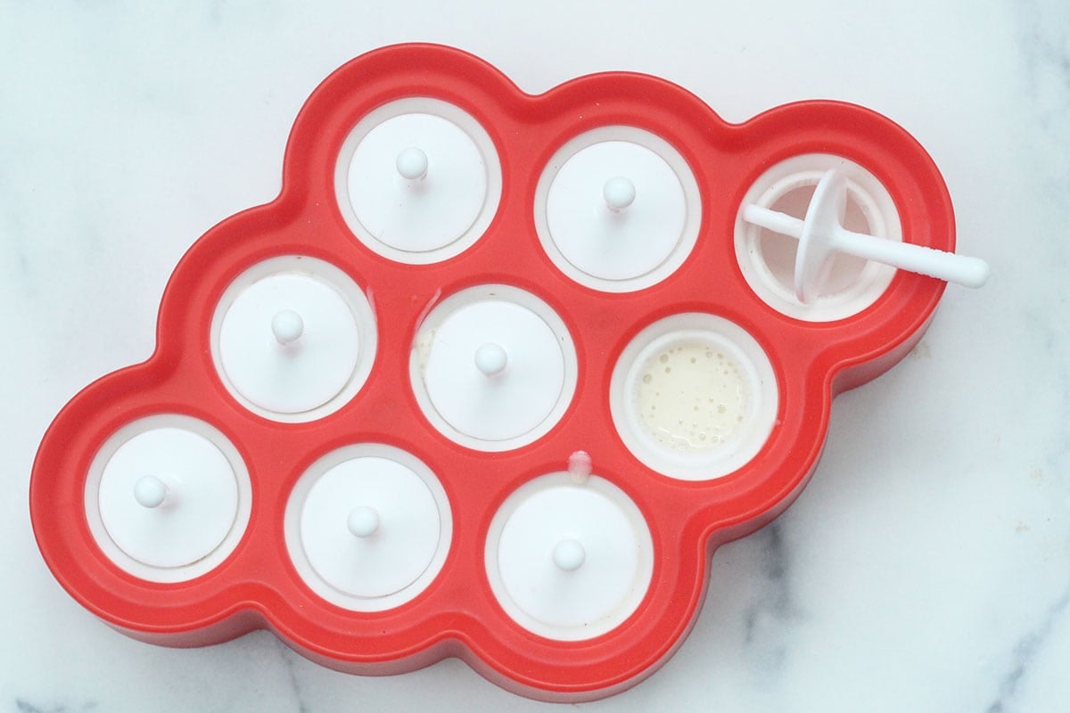 banana popsicle mixture in popsicle molds.