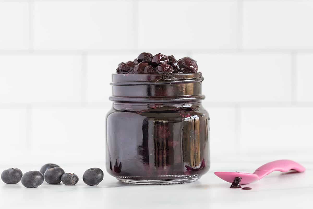 blueberry sauce in jar on counter.