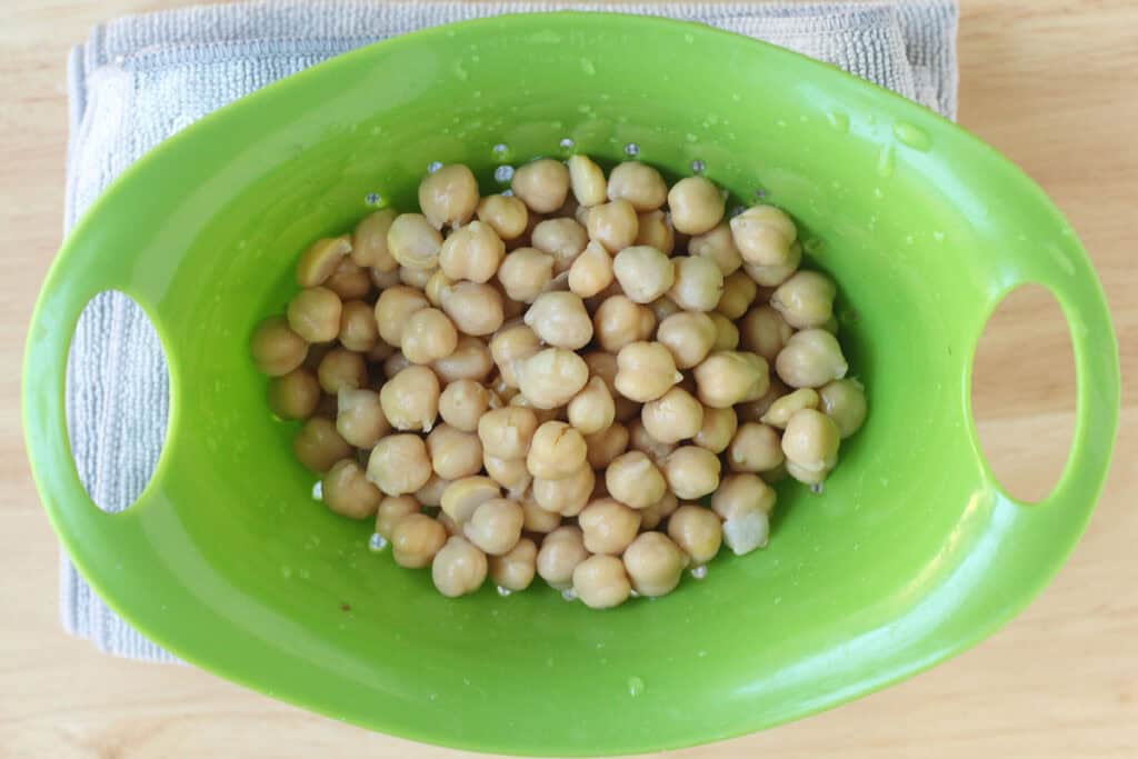 chickpeas in green colander.