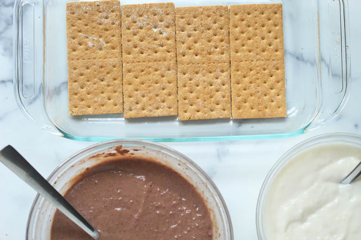 pudding in bowls with pan of graham crackers.