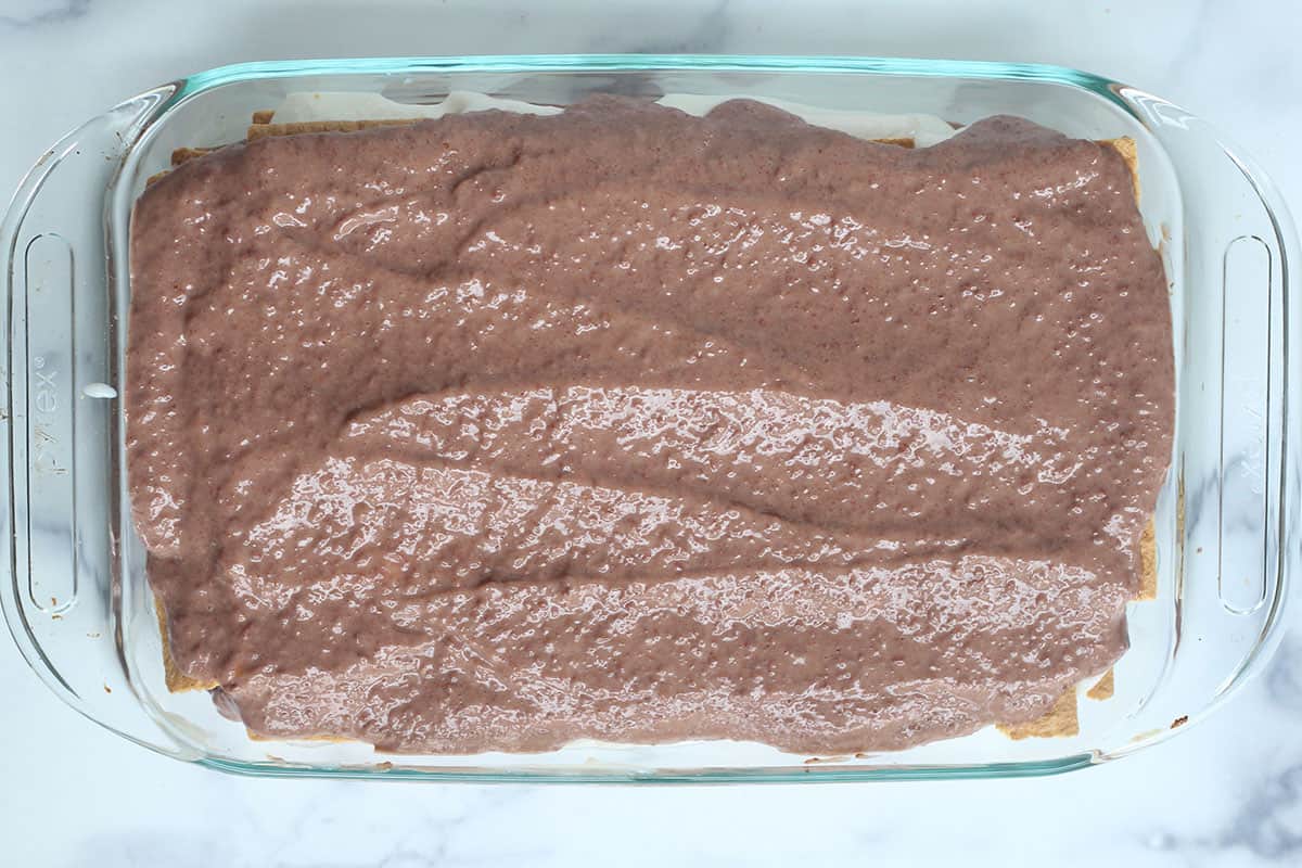 chocolate pudding layer of ice box cake in baking dish.