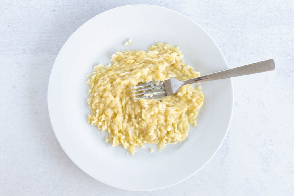 mashed banana in white bowl