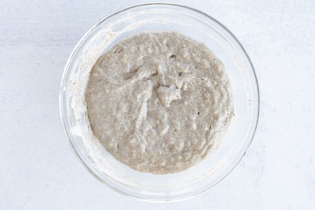 batter for vegan banana pancakes in glass bowl.