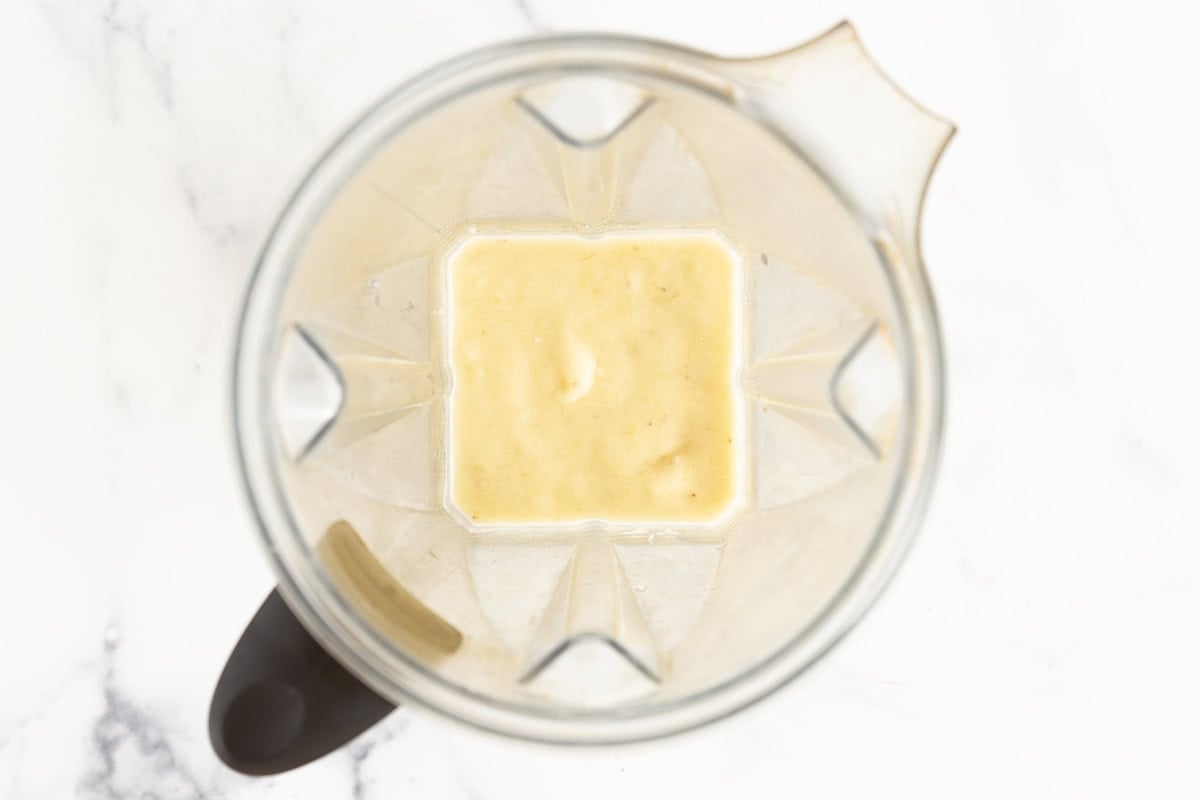 Bananas being blended in blender for banana pudding.