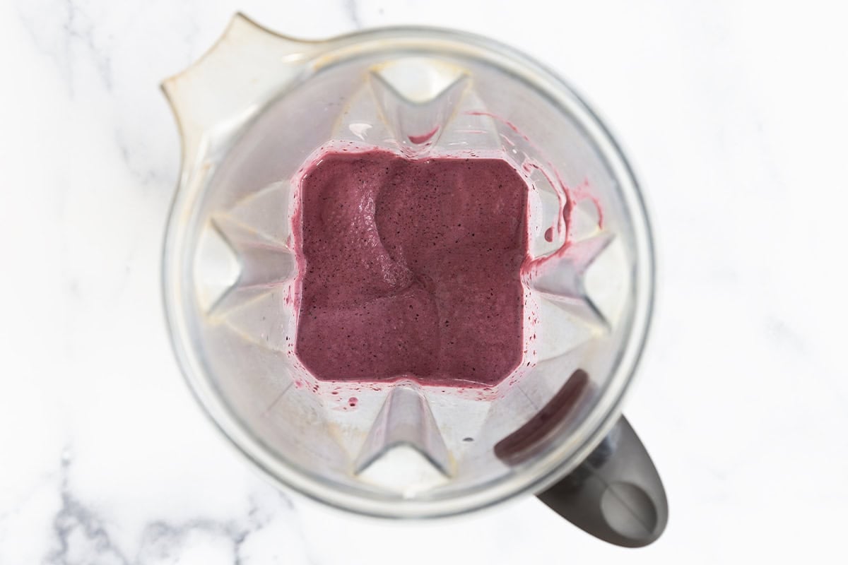 blended mixture for blueberry popsicles in blender.