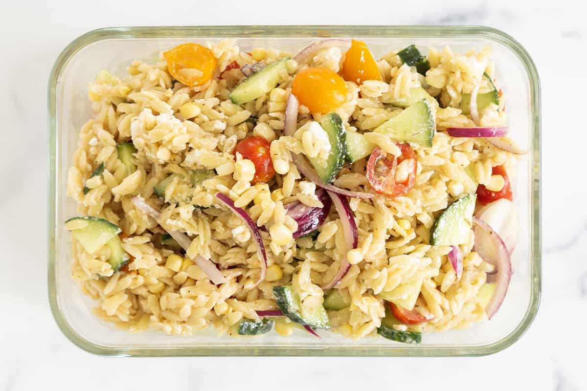 Orzo pasta salad in glass container.