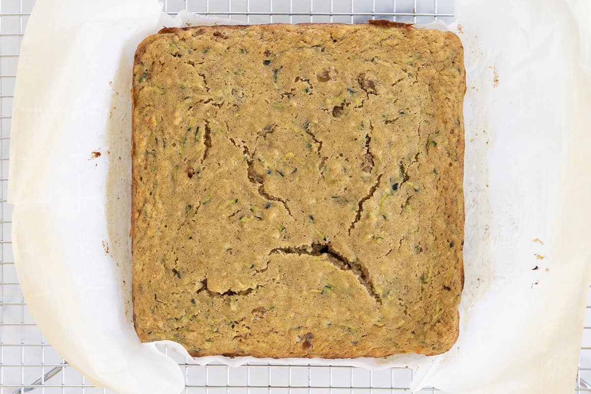 Zucchini cake on cooling rack.