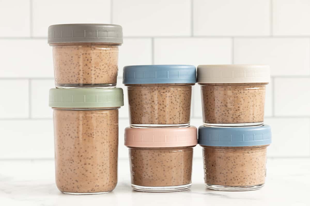 Chocolate chia pudding in glass containers stacked.