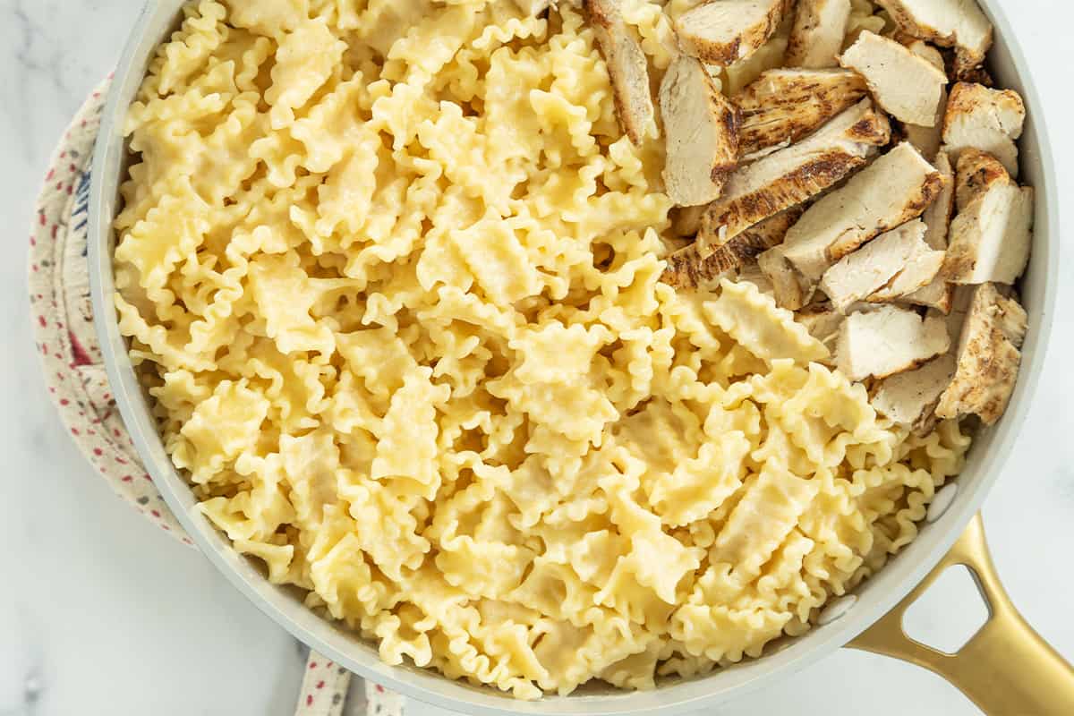 Creamy chicken pasta close up in pan.