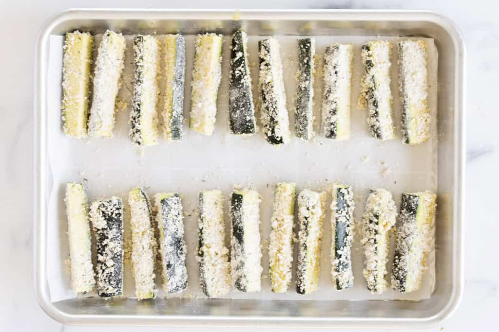 Zucchini fries on baking sheet before baking.