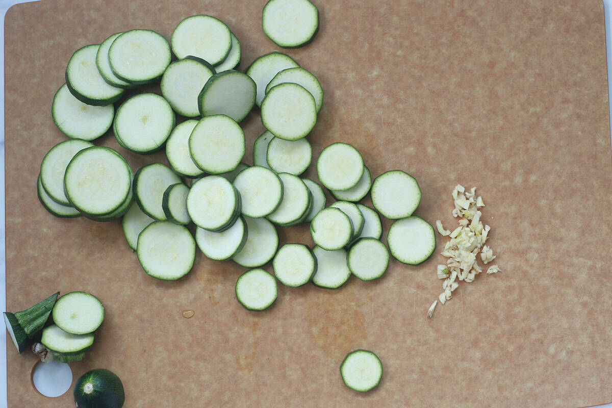 sliced zucchini on cutting board.