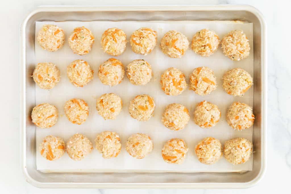 Chicken meatballs on baking sheet before baking.